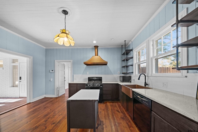 kitchen with ornamental molding, a kitchen island, dark wood-type flooring, and black appliances