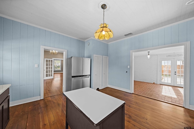 kitchen with stainless steel fridge, dark hardwood / wood-style flooring, and a healthy amount of sunlight