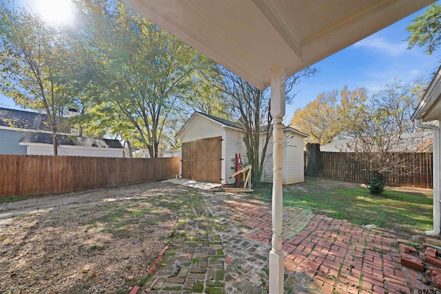 view of yard featuring a patio and a shed