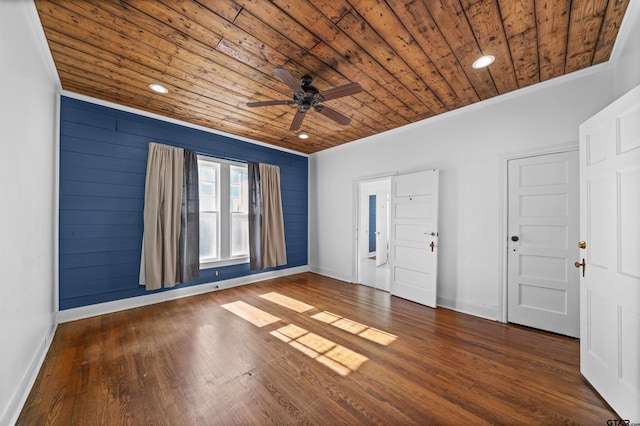 foyer entrance featuring dark hardwood / wood-style flooring, ceiling fan, wood walls, and wood ceiling