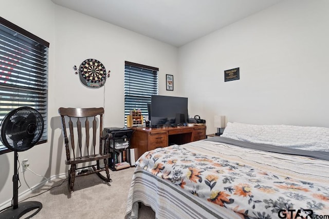 bedroom with baseboards and light colored carpet