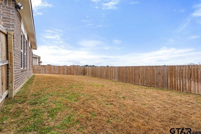 view of yard with a fenced backyard