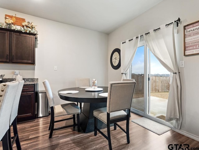 dining area featuring dark wood-style flooring