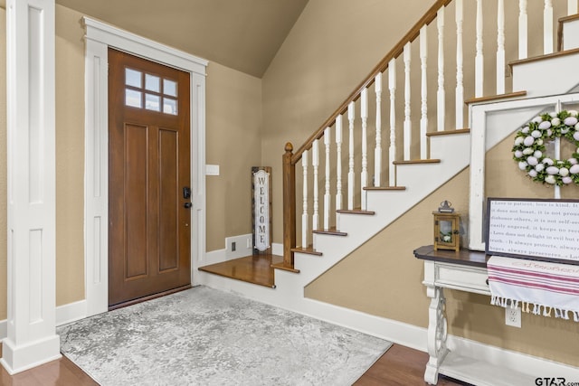 entrance foyer with hardwood / wood-style floors and lofted ceiling