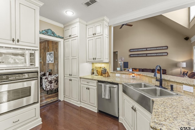 kitchen with backsplash, stainless steel appliances, ceiling fan, sink, and white cabinets