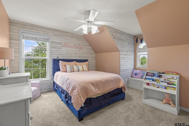 carpeted bedroom with ceiling fan and vaulted ceiling