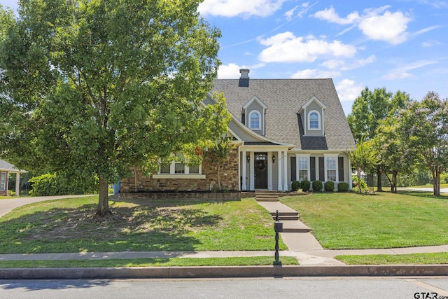 cape cod house featuring a front lawn