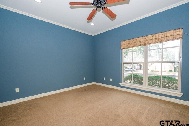 carpeted spare room with crown molding, ceiling fan, and plenty of natural light