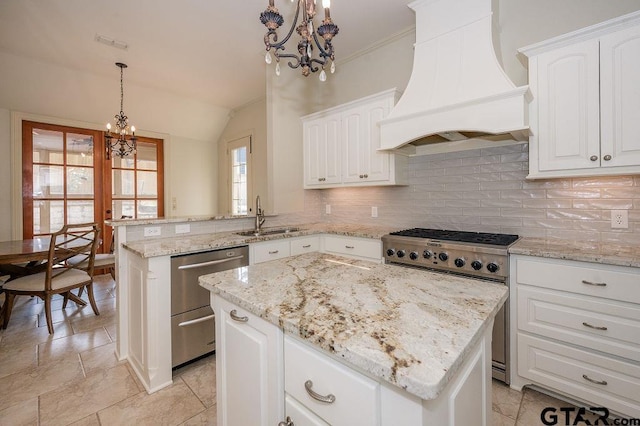 kitchen featuring premium range hood, hanging light fixtures, a center island, a notable chandelier, and stainless steel appliances