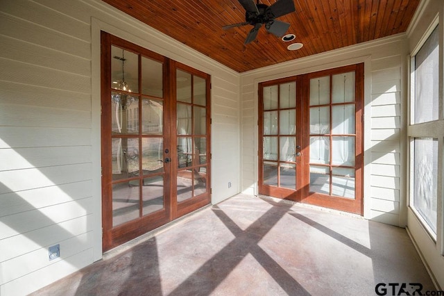 unfurnished sunroom featuring french doors, wood ceiling, and plenty of natural light