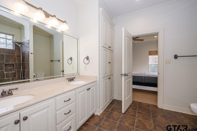 bathroom with crown molding, a wealth of natural light, vanity, and toilet