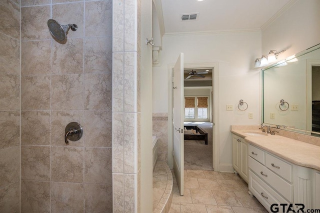 bathroom with a tile shower, vanity, and crown molding