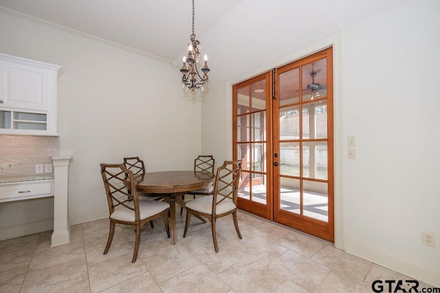 dining room featuring crown molding, an inviting chandelier, and french doors