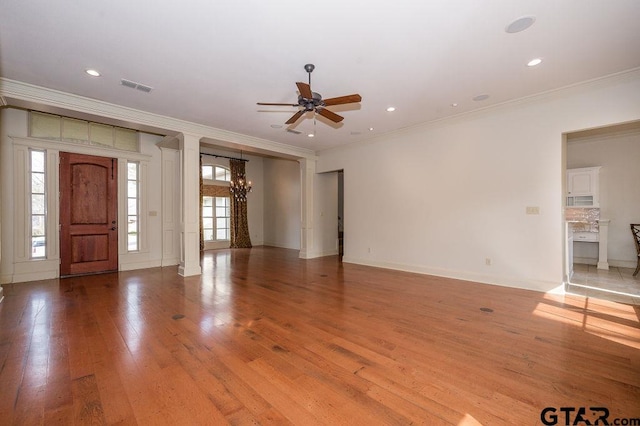 foyer featuring ornamental molding, ceiling fan with notable chandelier, and light hardwood / wood-style flooring