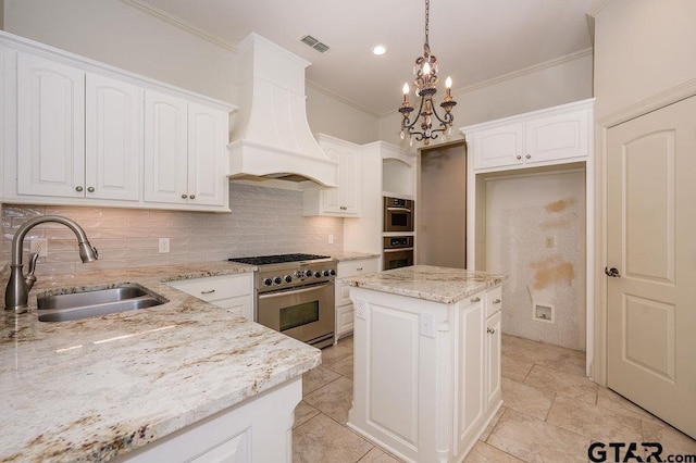 kitchen with pendant lighting, sink, high end stainless steel range oven, a kitchen island, and custom exhaust hood