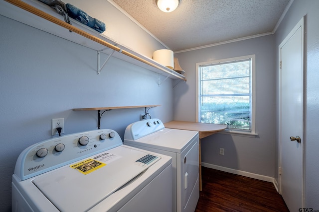 laundry room featuring washer and dryer, dark hardwood / wood-style flooring, a textured ceiling, and crown molding