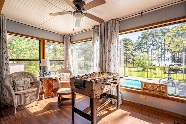 sunroom featuring ceiling fan