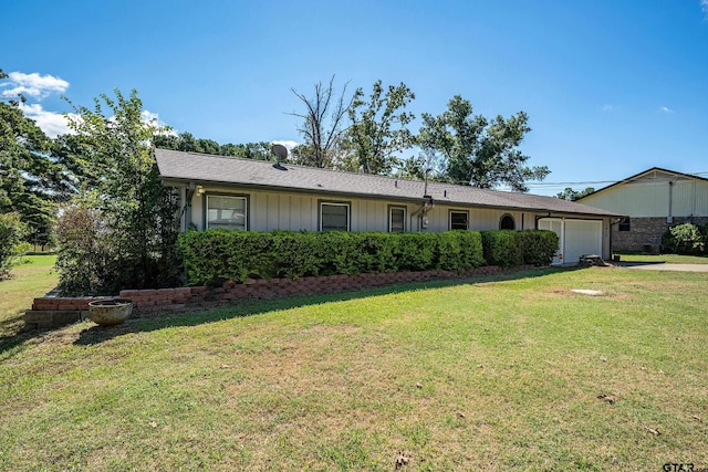 ranch-style house with a front yard and a garage