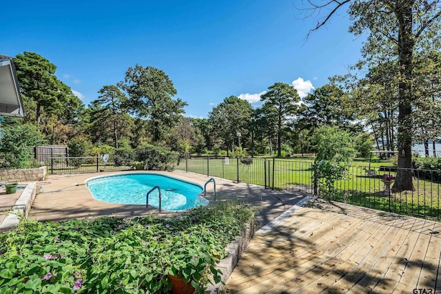 view of pool with a yard