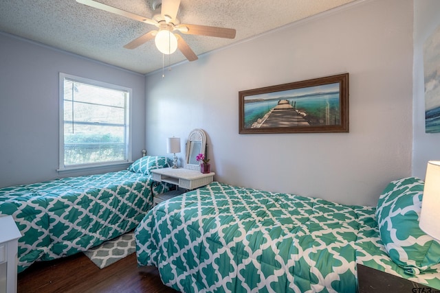 bedroom with hardwood / wood-style floors, ceiling fan, ornamental molding, and a textured ceiling