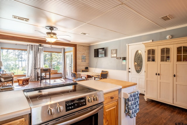 kitchen featuring ceiling fan, stainless steel stove, dark wood-type flooring, and wooden ceiling