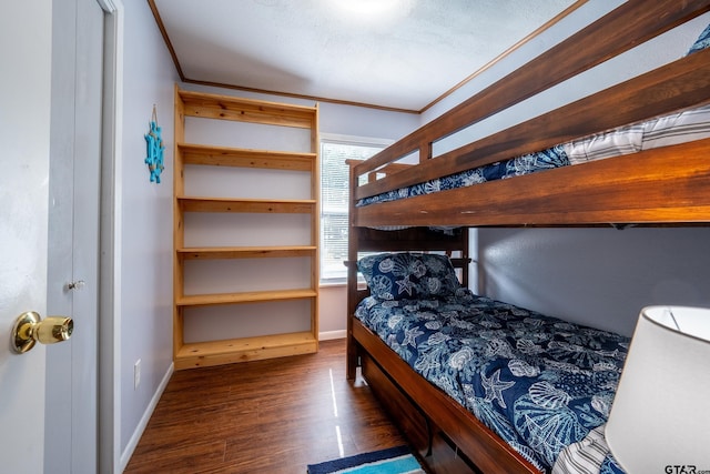 bedroom with dark wood-type flooring and ornamental molding