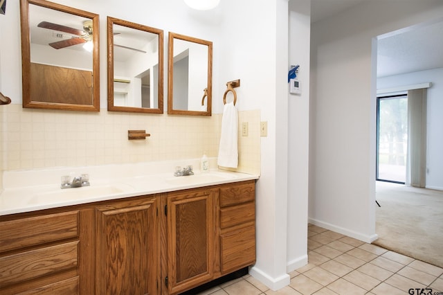 2759 Lake Breeze Dr, Chandler, TX 75758 - full bathroom featuring backsplash, a ceiling fan, double vanity, tile patterned flooring, and baseboards