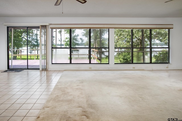 2759 Lake Breeze Dr, Chandler, TX 75758 - empty room with plenty of natural light, a ceiling fan, and light tile patterned flooring