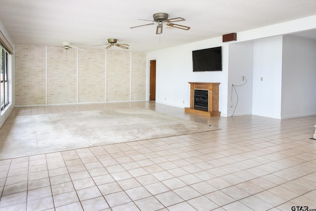 2759 Lake Breeze Dr, Chandler, TX 75758 - unfurnished living room with a ceiling fan, a fireplace, and baseboards