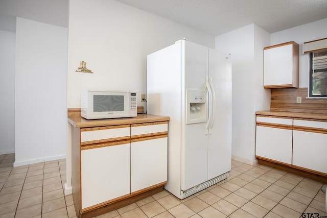 2759 Lake Breeze Dr, Chandler, TX 75758 - kitchen with white appliances, light countertops, and white cabinetry