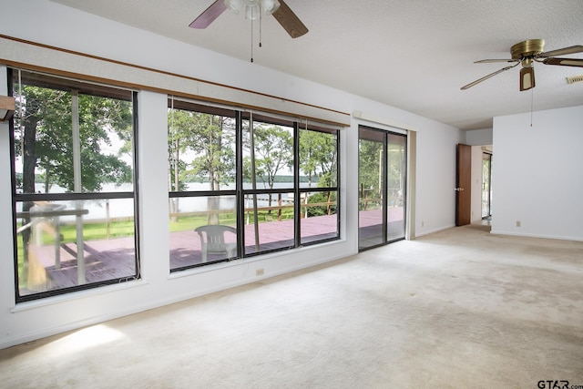 2759 Lake Breeze Dr, Chandler, TX 75758 - carpeted spare room featuring ceiling fan, a water view, and baseboards