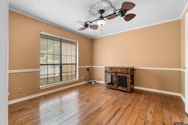 507 Hyde Park, Tyler, TX 75701 - unfurnished living room with wood-type flooring, a textured ceiling, ornamental molding, and a ceiling fan