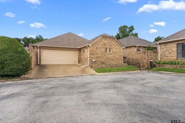 507 Hyde Park, Tyler, TX 75701 - view of front of property featuring brick siding, driveway, a garage, and a shingled roof