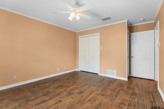 507 Hyde Park, Tyler, TX 75701 - unfurnished bedroom with dark wood-style flooring, a textured ceiling, a closet, a ceiling fan, and crown molding
