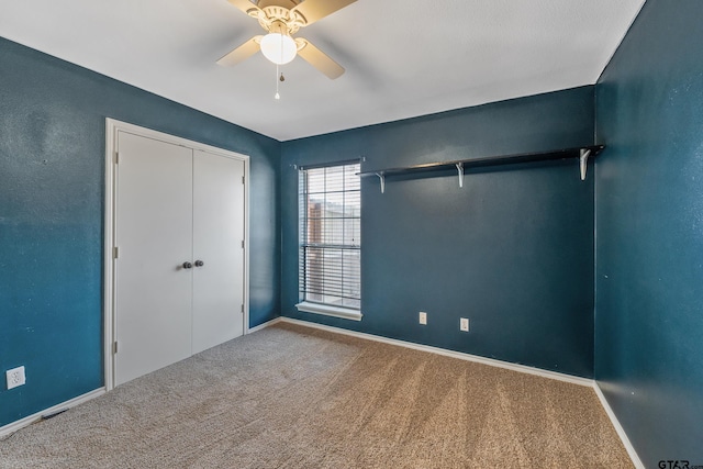 unfurnished bedroom with a ceiling fan, carpet, baseboards, and a closet