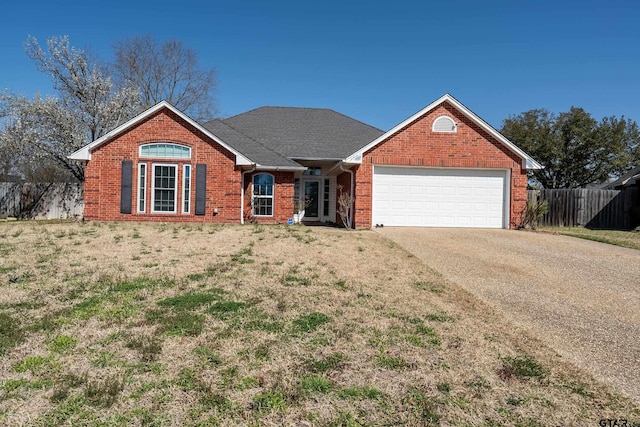 ranch-style house featuring a front lawn, fence, concrete driveway, an attached garage, and brick siding