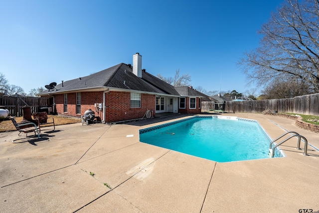 view of swimming pool with a fenced in pool, a patio, and a fenced backyard