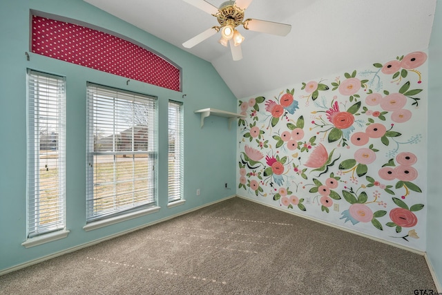 unfurnished room with vaulted ceiling, carpet flooring, a ceiling fan, and baseboards