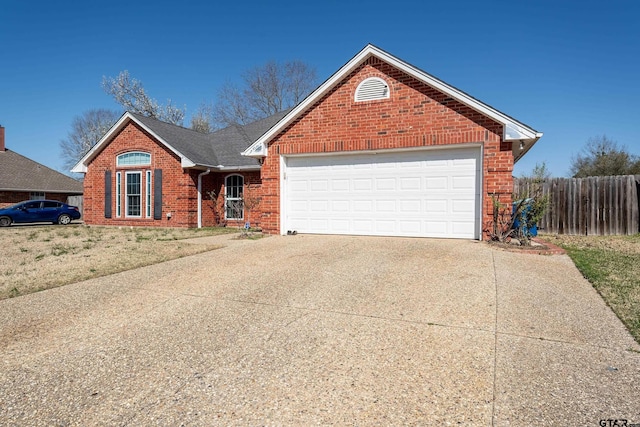 view of front of home with brick siding, a shingled roof, fence, concrete driveway, and a garage