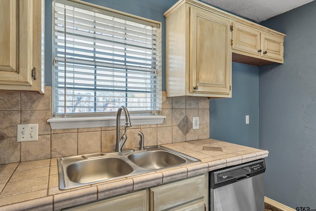 kitchen featuring light brown cabinetry, a sink, tasteful backsplash, tile countertops, and dishwasher