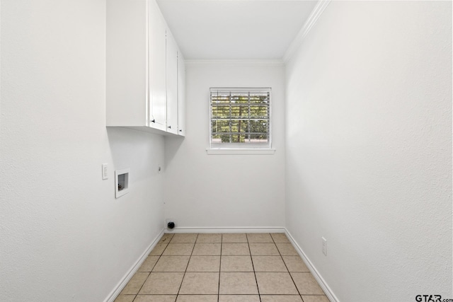 laundry room with crown molding, electric dryer hookup, washer hookup, baseboards, and cabinet space