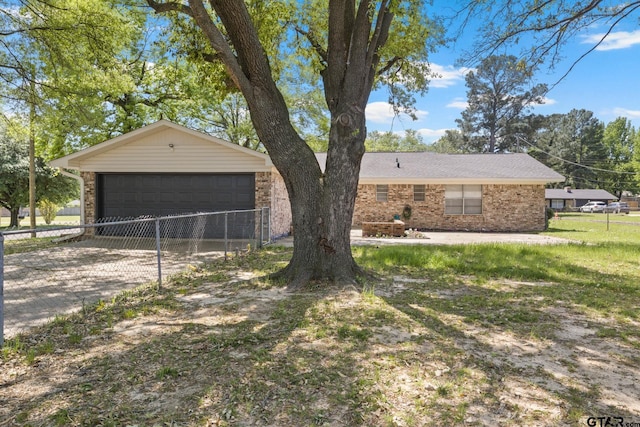 view of front of property with brick siding, fence, a garage, and an outbuilding