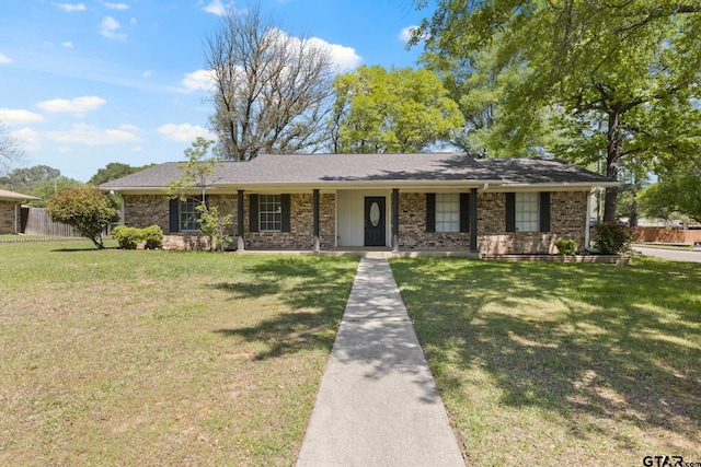 view of front of home with a front yard and brick siding