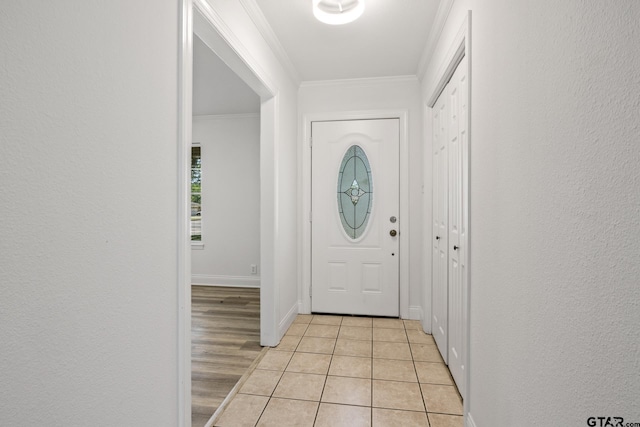 interior space with crown molding, light tile patterned floors, and baseboards