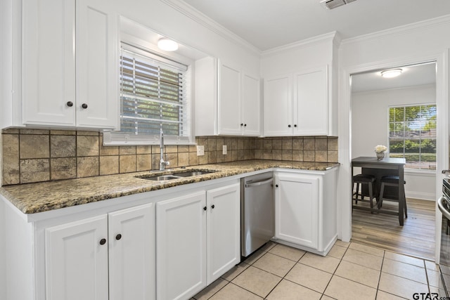 kitchen featuring dishwasher, a sink, ornamental molding, and white cabinets