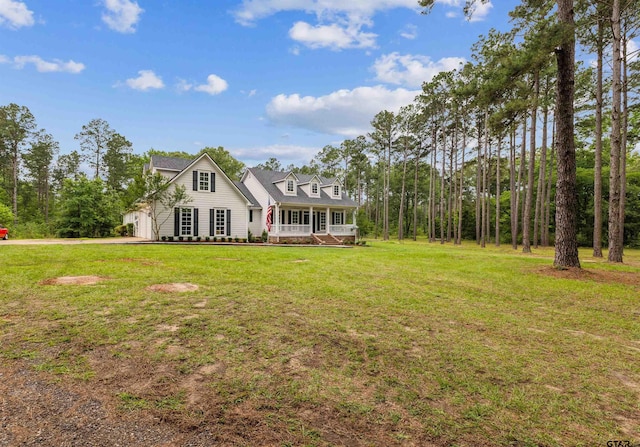 cape cod house featuring a front yard, an attached garage, and driveway