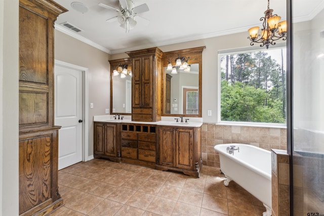 full bathroom with crown molding, a freestanding tub, a chandelier, ceiling fan, and tile patterned floors