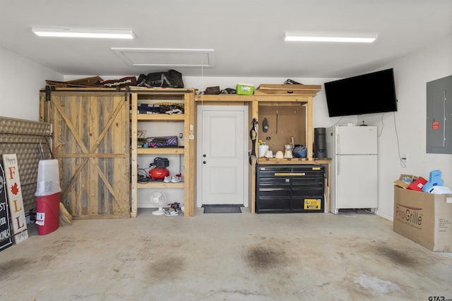 garage with white fridge and electric panel