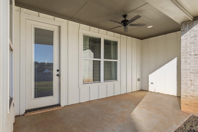 entrance to property with ceiling fan and a patio area