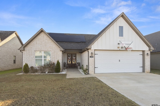 view of front of house with french doors, a front yard, and solar panels